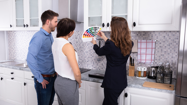 couple picking paint for kitchen