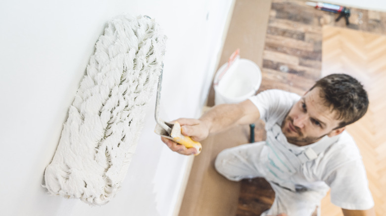 person using a paint roller