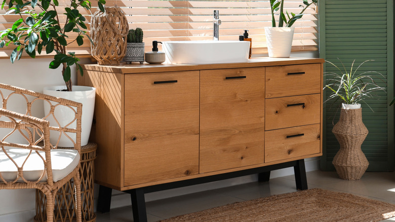 An old dresser that has been upcycled into a stylish bathroom vanity