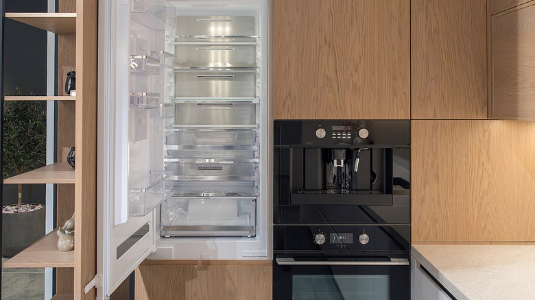 Refrigerator housed inside a cabinet