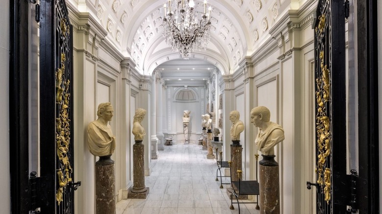 Stone arched hallway with statues