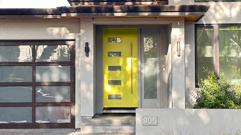 Yellow front door of mid-century, one-story building