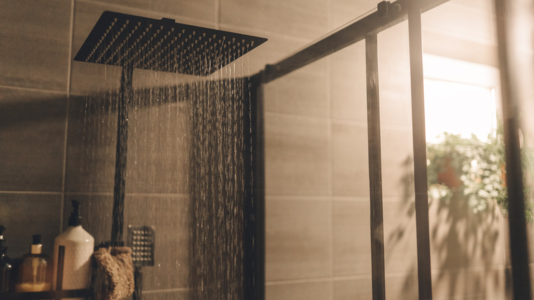 Close up of Water flowing from shower in the bathroom interior