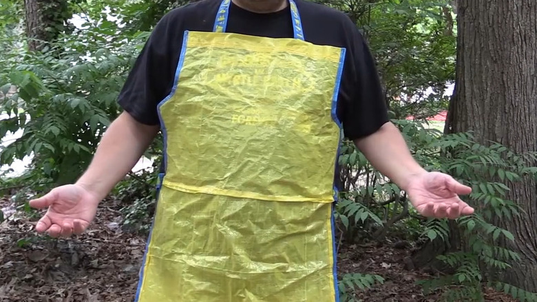 Man wearing yellow and blue apron made from IKEA bags
