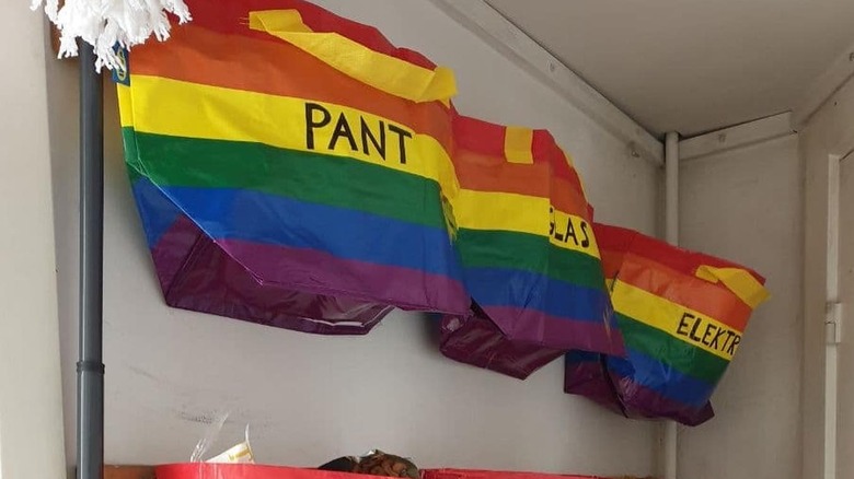 Rainbow colored IKEA bags mounted on a wall for organization