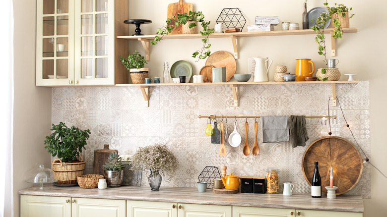 A rustic family kitchen has a copper rail set above the countertop