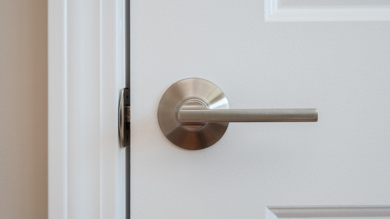 Silver doorknob white door