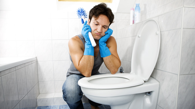 Man staring at toilet