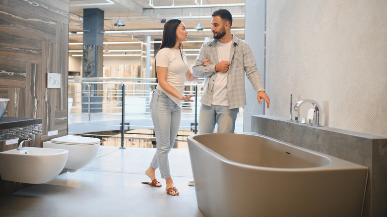Couple looking at tub in bathroom showroom