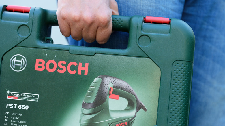 Man carrying a green jigsaw case