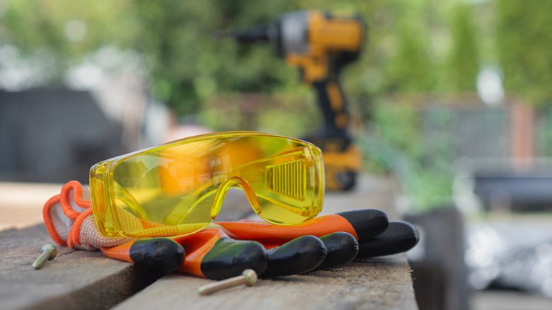 Yellow safety goggles and red gloves