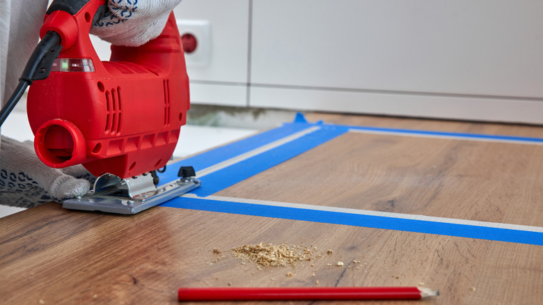 Blue tape used for a jigsaw cut on wood