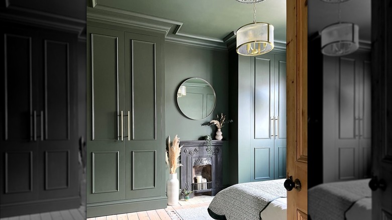 IKEA PAX wardrobes installed as built in closets separated by a faux fireplace in a bedroom.