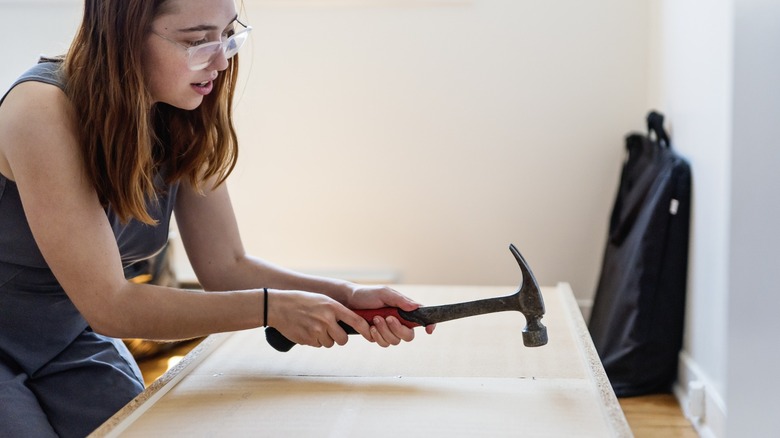 Woman assembling furniture piece