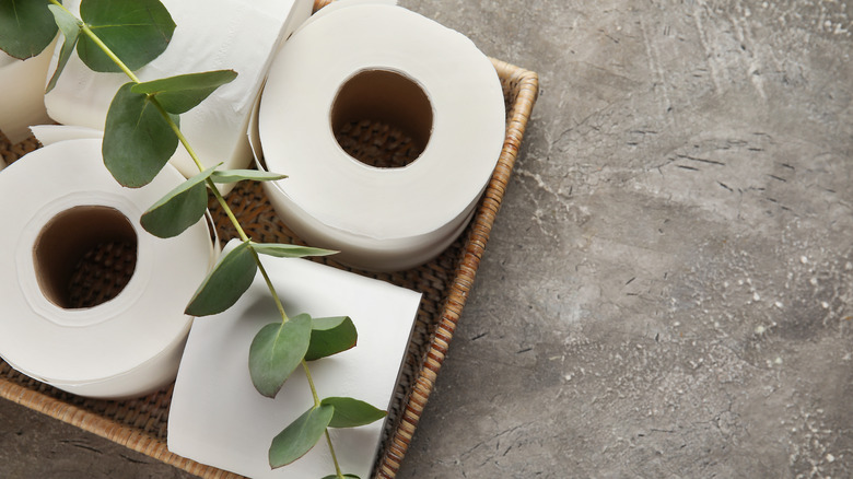 Toilet paper rolls stored in wicker basket