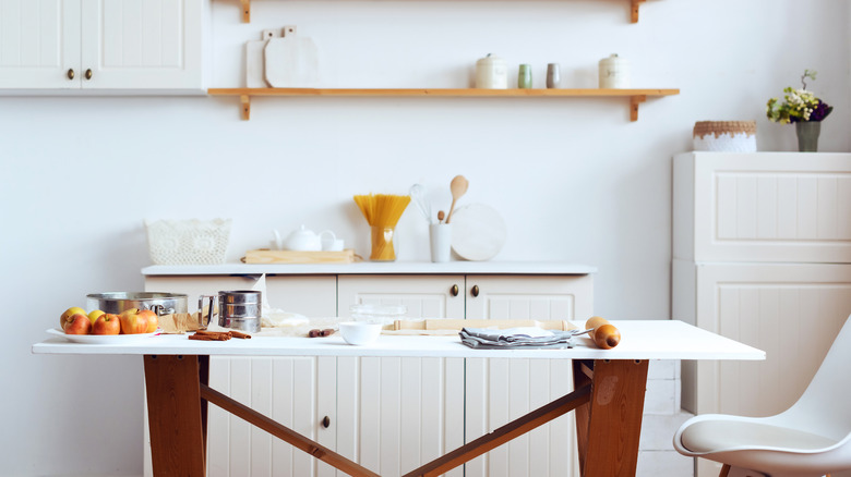 Kitchen table with white cabinets behind