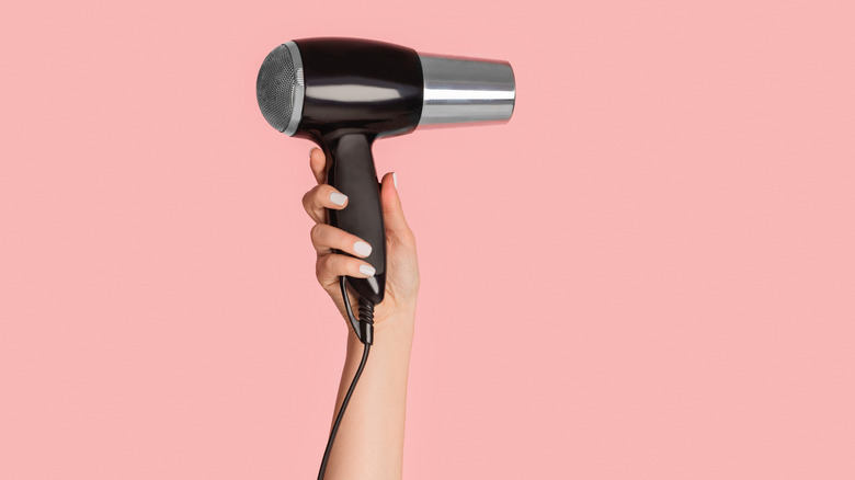 Hand holding hairdryer