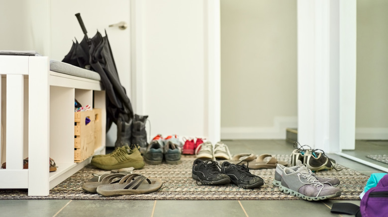 mess of shoes at the front door