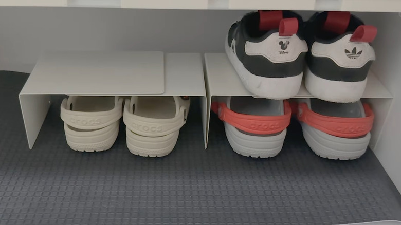 A mom repurposed bookends to make a small kids' shoe shelf.