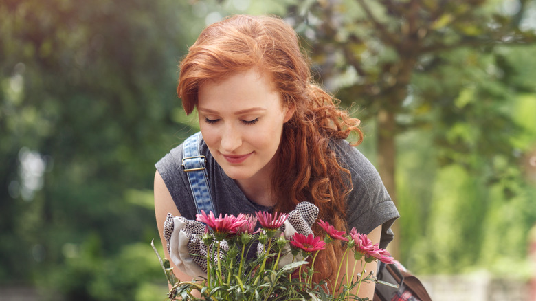 Woman growing flowers in garden