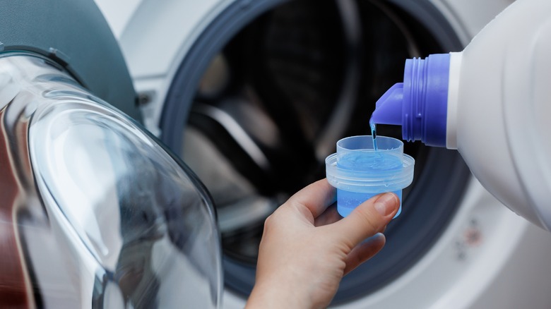 pouring laundry detergent