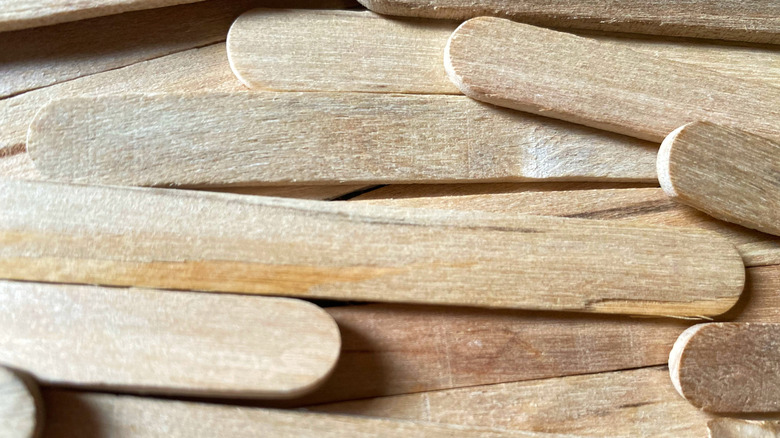 close-up of a pile of wooden popsicle sticks.