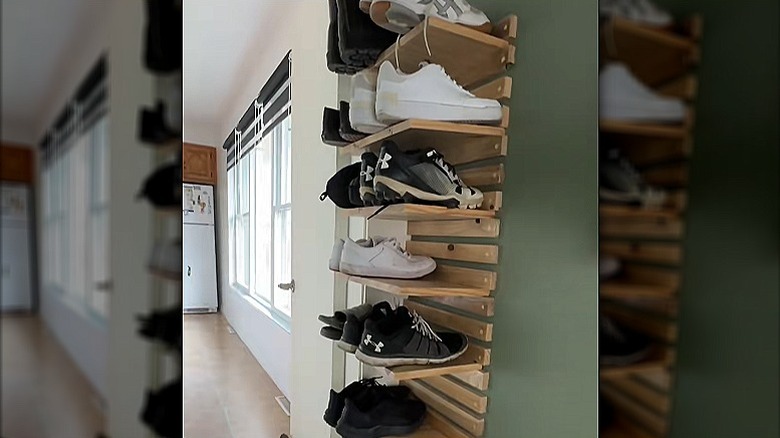 A clever multi-level shoe rack make from bits of wood and attached to a wall