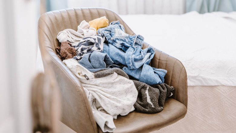 chair full of unfolded laundry