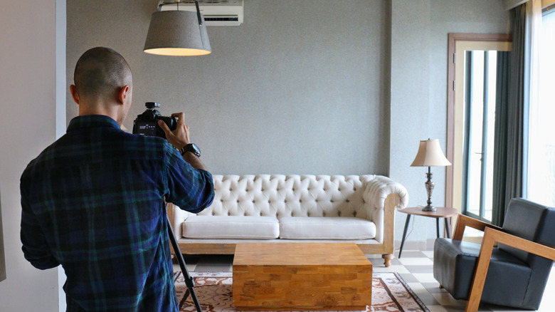 A man photographing a room for real estate pictures