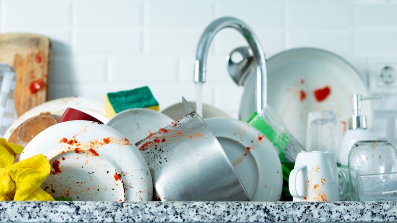 Person scrubbing a dirty pan