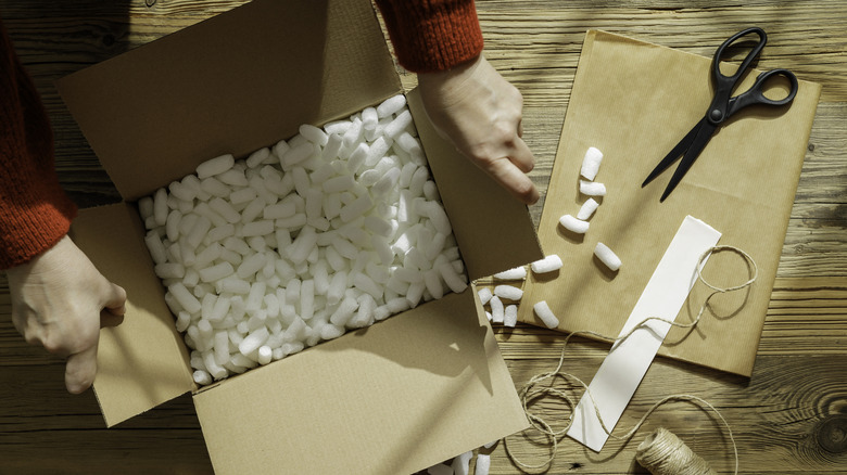 Someone opening a box full of Styrofoam