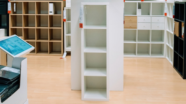 A white storage cube organizer with wicker baskets.