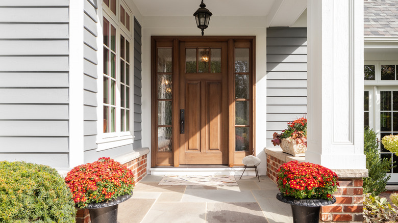 A rustic style home with wood doors and flowers
