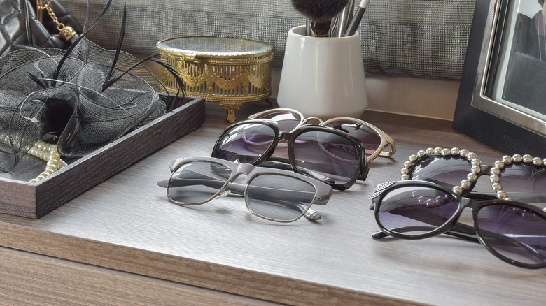 Dresser with pairs of sunglasses