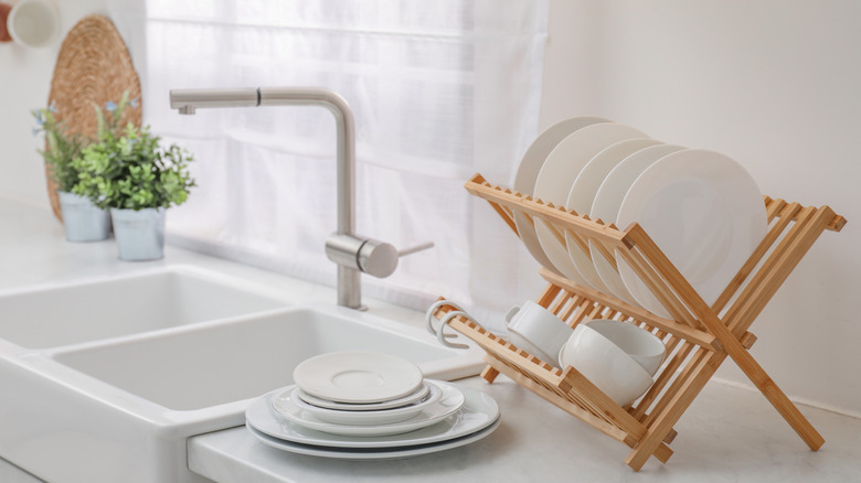 Dishes drying on a wooden rack
