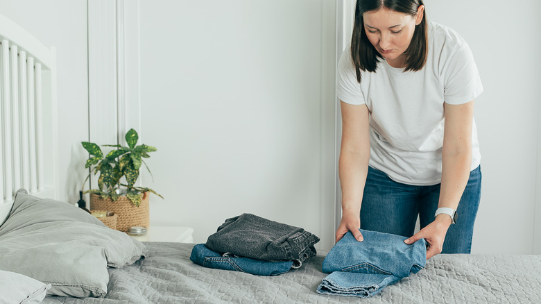 Woman folding jeans