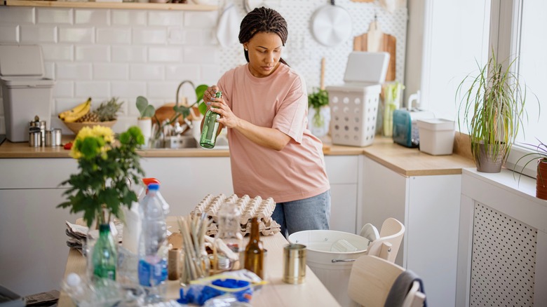 Woman in cluttered kitchen