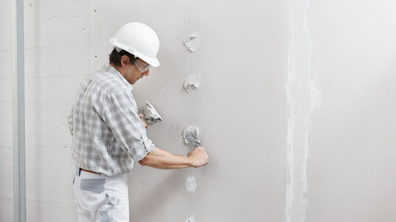 Man repairing drywall