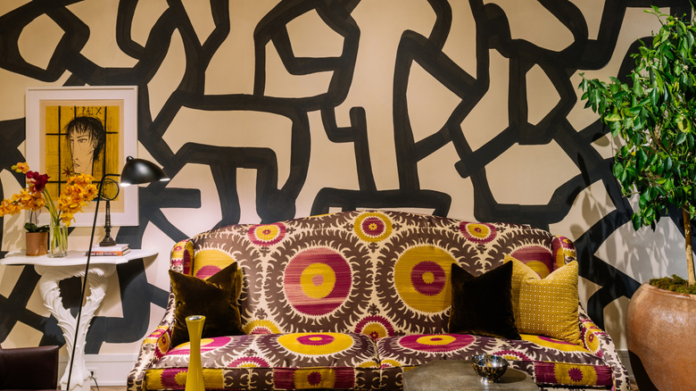 A living room with lots of textures and patterns including black lines and colorful circles