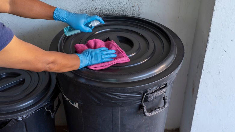 woman starts cleaning trash can