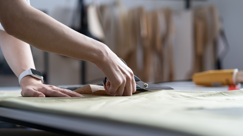 Close up of person cutting fabric