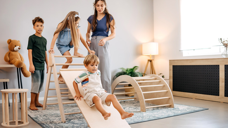 Children playing on indoor Montessori slide