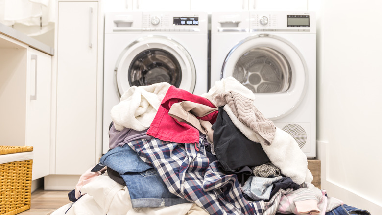 Laundry room with a pile of clothes on the floor
