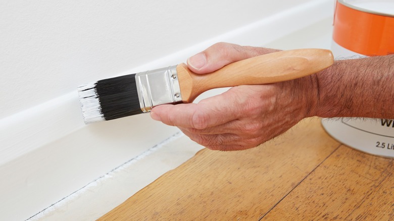 Close up of painting baseboard