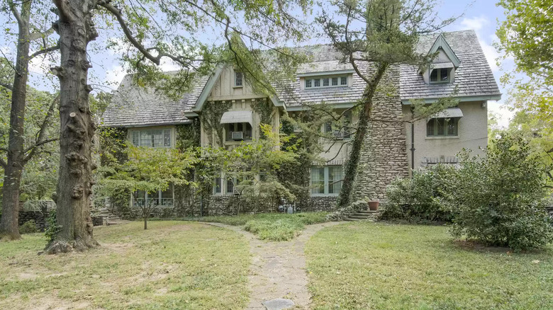 Large stone mansion exterior trees