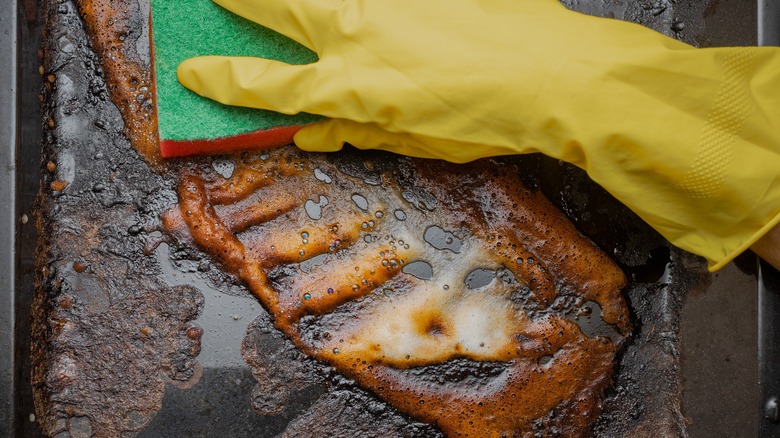 wiping down filthy oven