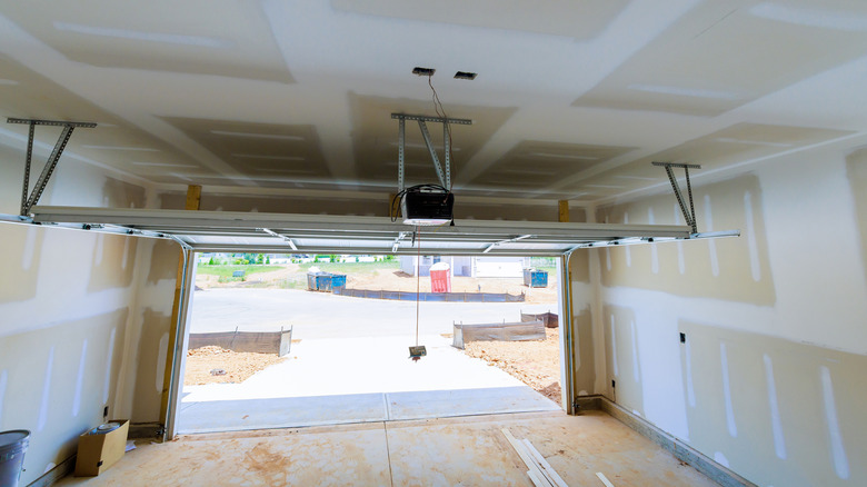 An empty garage with a view of the space above the garage door