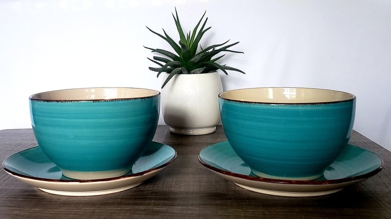 Two turquoise bowls on a table