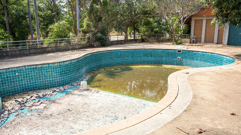 Old run down swimming pool in a home