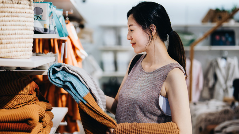woman choosing rug in store